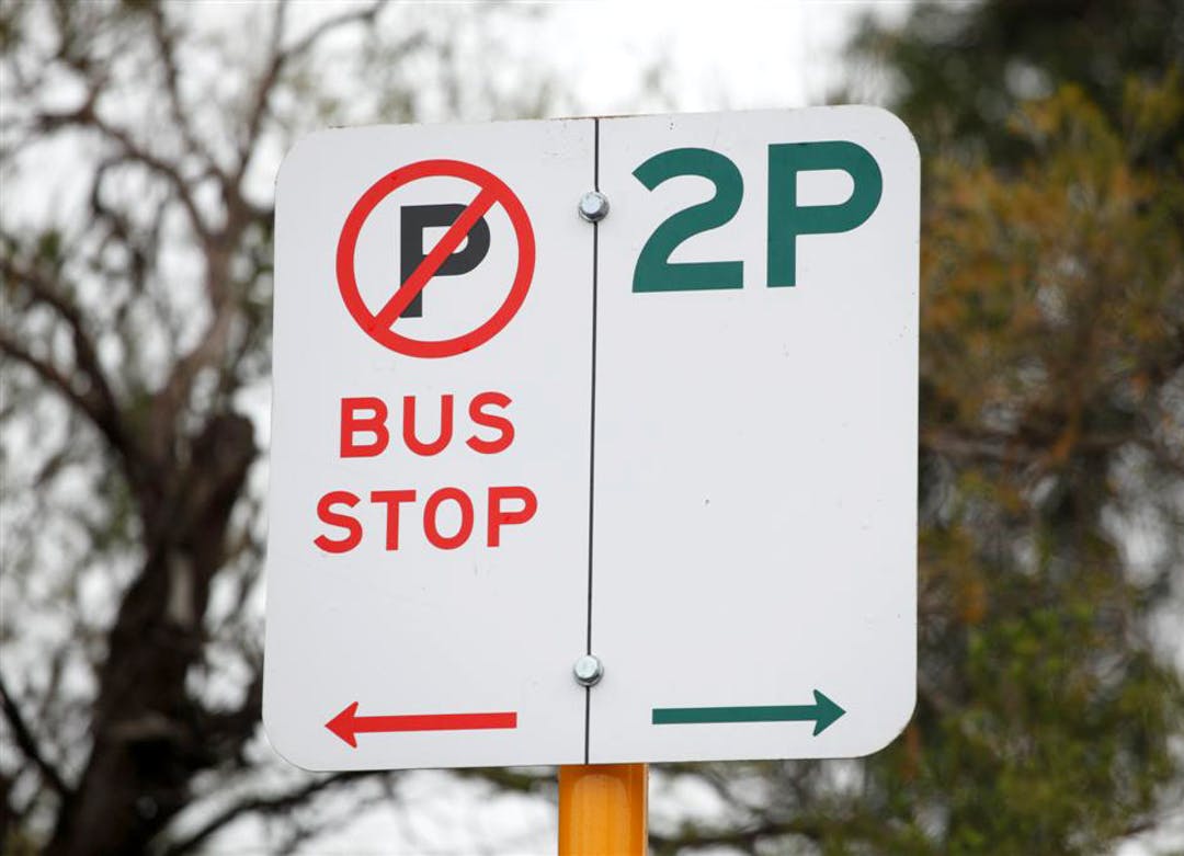 Parking Sign showing no parking on the left as it is a Bus stop & 2 hour parking limit on the right