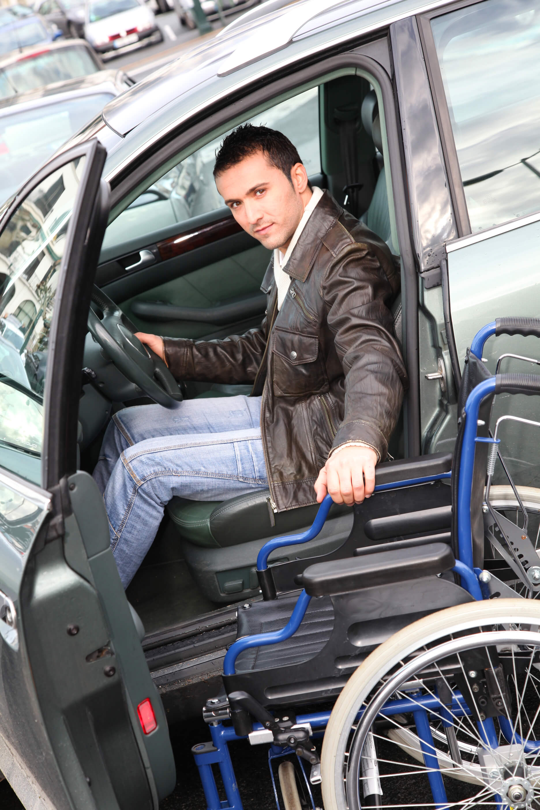 Man getting out of a car into a wheelchair independently