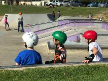 Three young kids watching the BMX/Skating action at the skate/bmx park located at Fleming Reserve in High Wycombe.