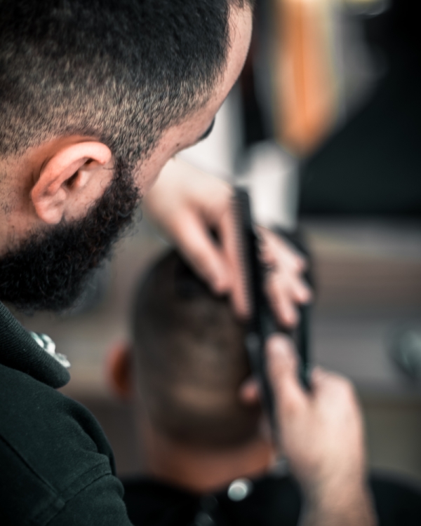 Image of person getting their hair cut at a barber shop