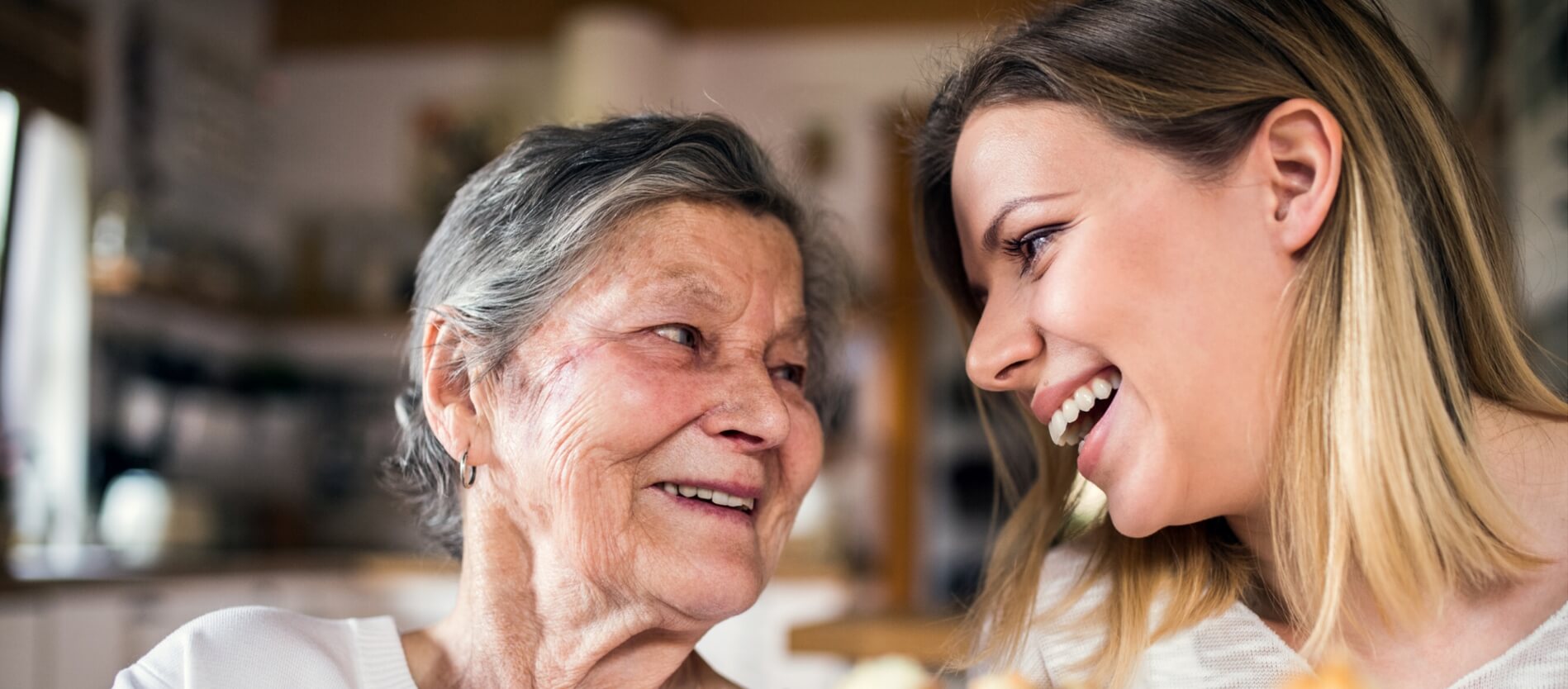 An older women looking and laughing with a younger women
