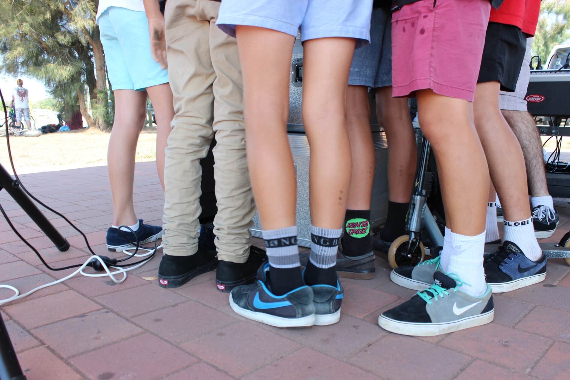 Kids listening to music at DJ stand - view of feet